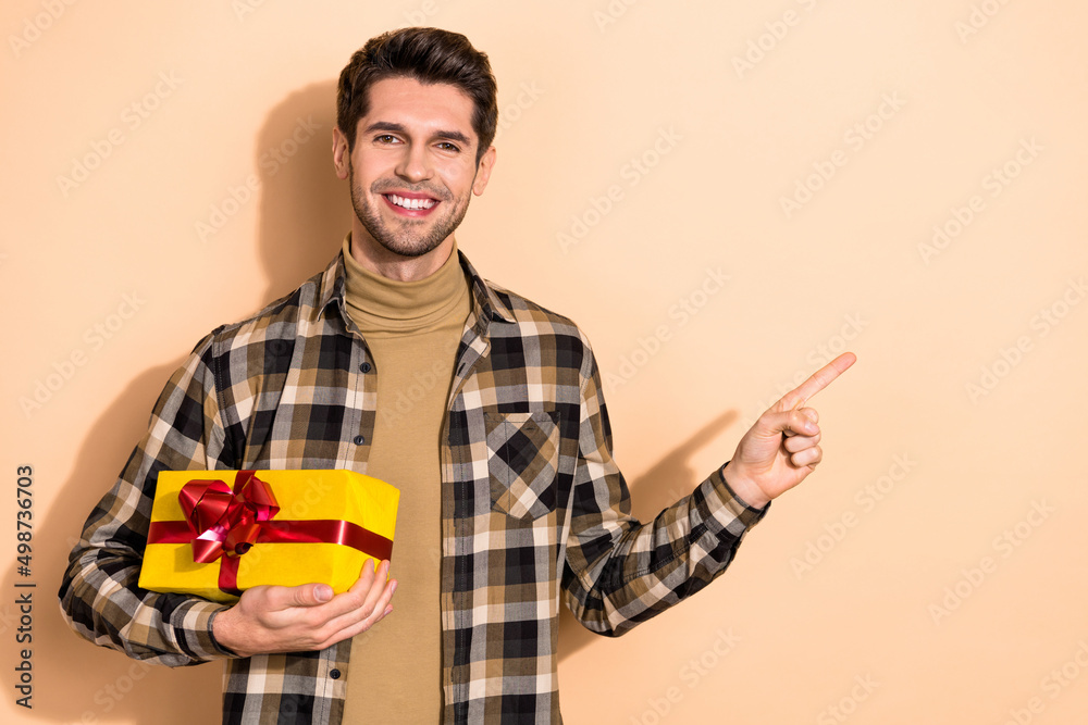 Photo of guy promoter demonstrate special offer package point empty space discounts isolated pastel color background Photo of guy promoter demonstrate special offer package point empty space discounts isolated pastel color background