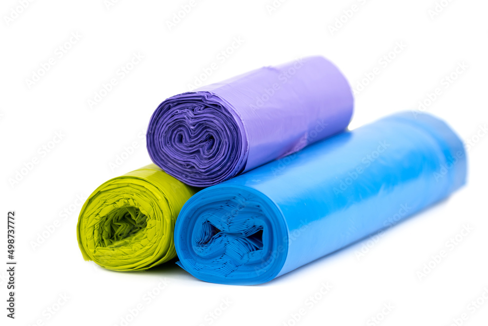 Stack of green, blue and purple garbage bags Stack of green, blue and purple garbage bags