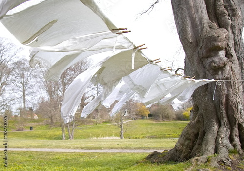 Old-fashioned laundry on a clothesline with wooden clips photo