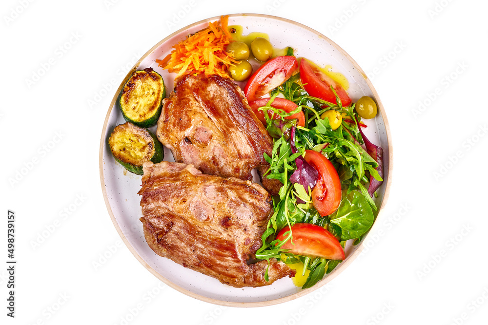 Fototapeta premium Roasted pork steaks with vegetable salad, isolated on white background.