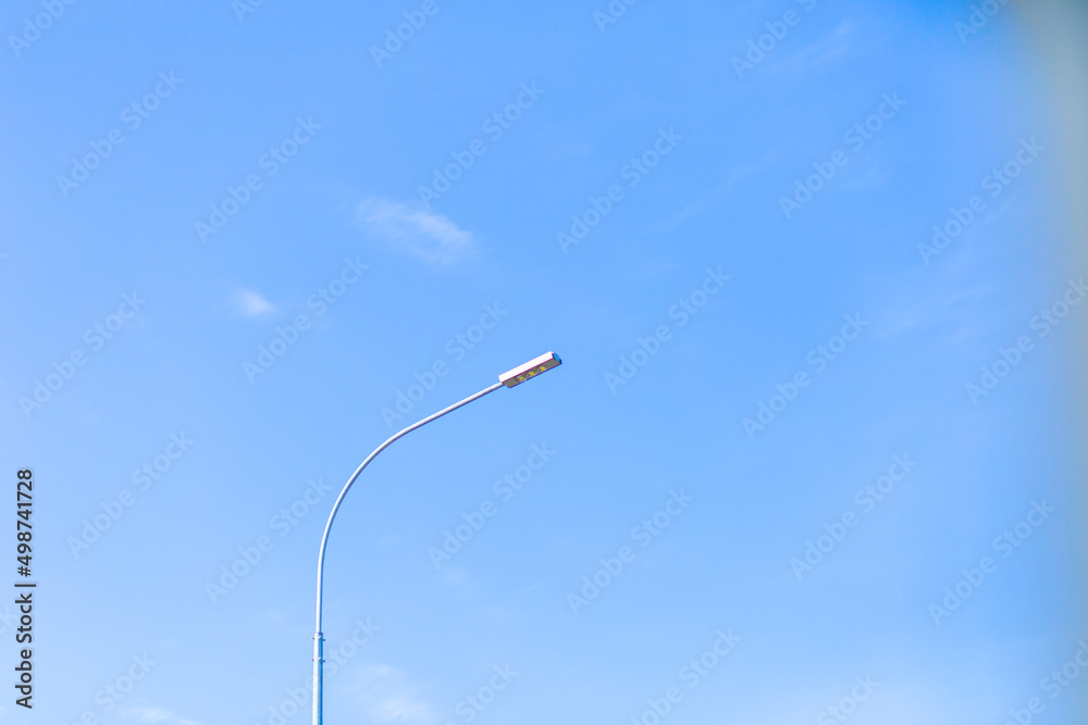 Modern street lamp on a blurred sky background Modern street lamp on a blurred sky background