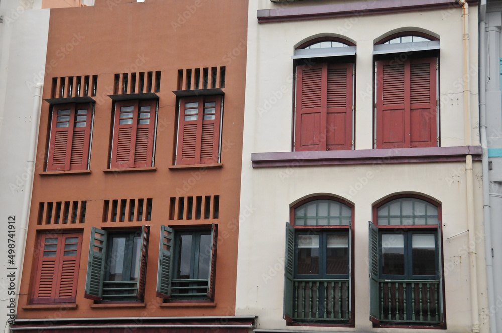 Classical dark orange and white grey front of town houses in Singapore in cloudy day