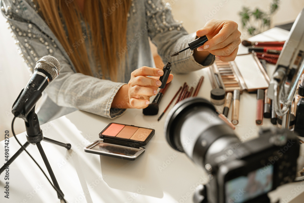 Female hands with eyebrow tint gel. Woman beauty blogger making a video review of cosmetic products. Female hands with eyebrow tint gel. Woman beauty blogger making a video review of cosmetic products.