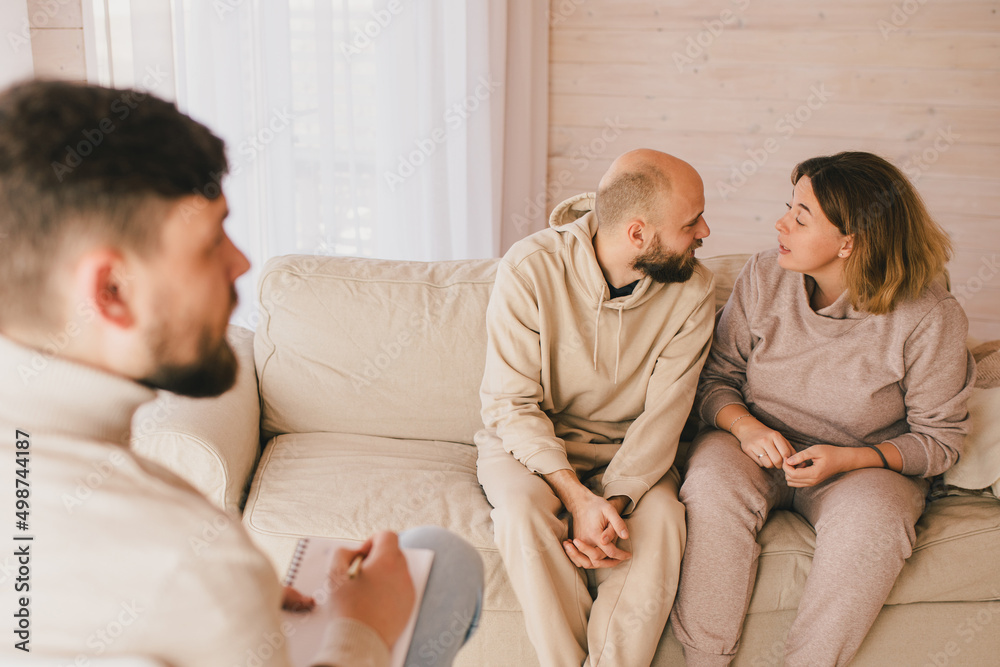 Psychiatrist consulting couple that have problems in their relationship. Mental support session. Psychiatrist consulting couple that have problems in their relationship. Mental support session.