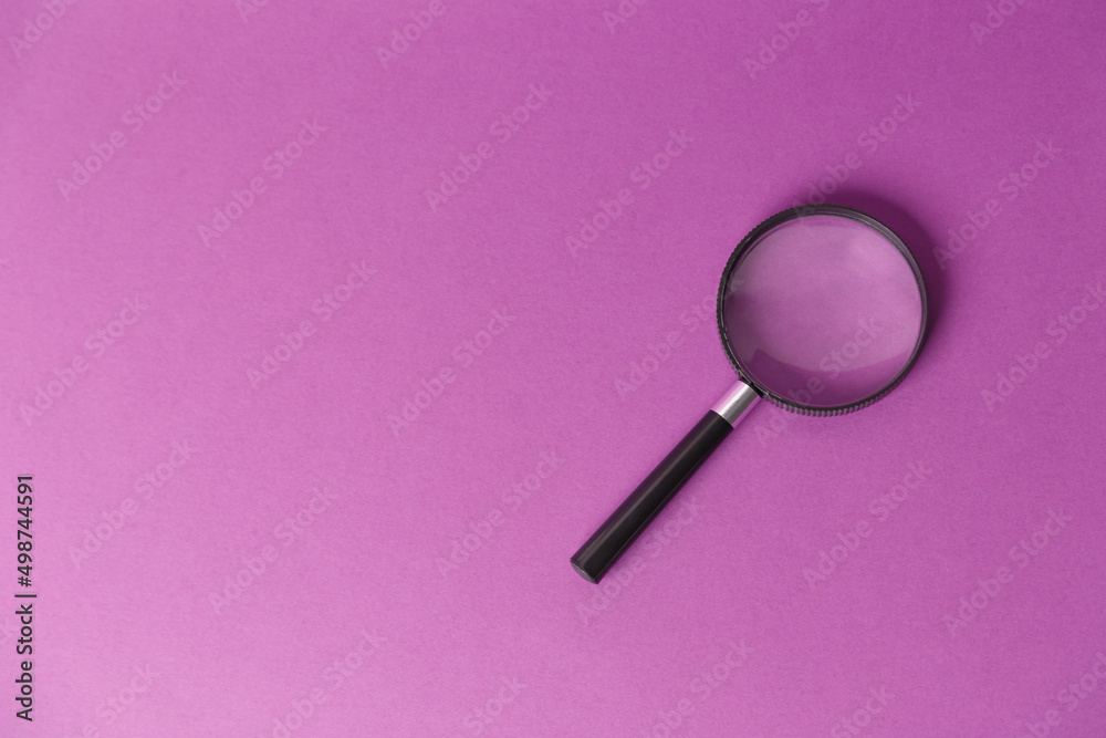 Magnifying glass isolated on a lilac background. Top view..Place to copy. Magnifying glass isolated on a lilac background. Top view..Place to copy.