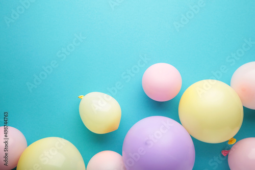 Birthday background with colorful balloons on blue background, top view