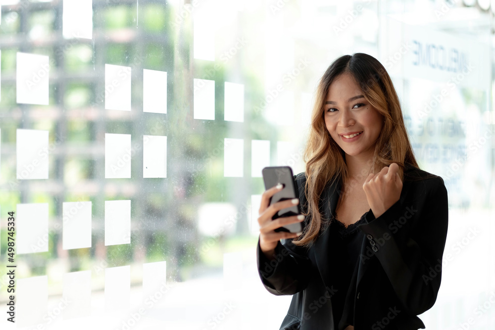 Beautiful asian woman using smartphone, exciting and celebrating with good news of business successful. Small business startup concept. Beautiful asian woman using smartphone, exciting and celebrating with good news of business successful. Small business startup concept.