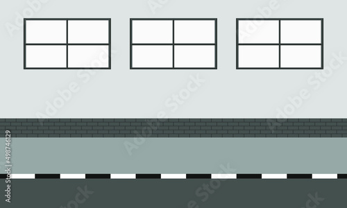 Sidewalk along wall with windows