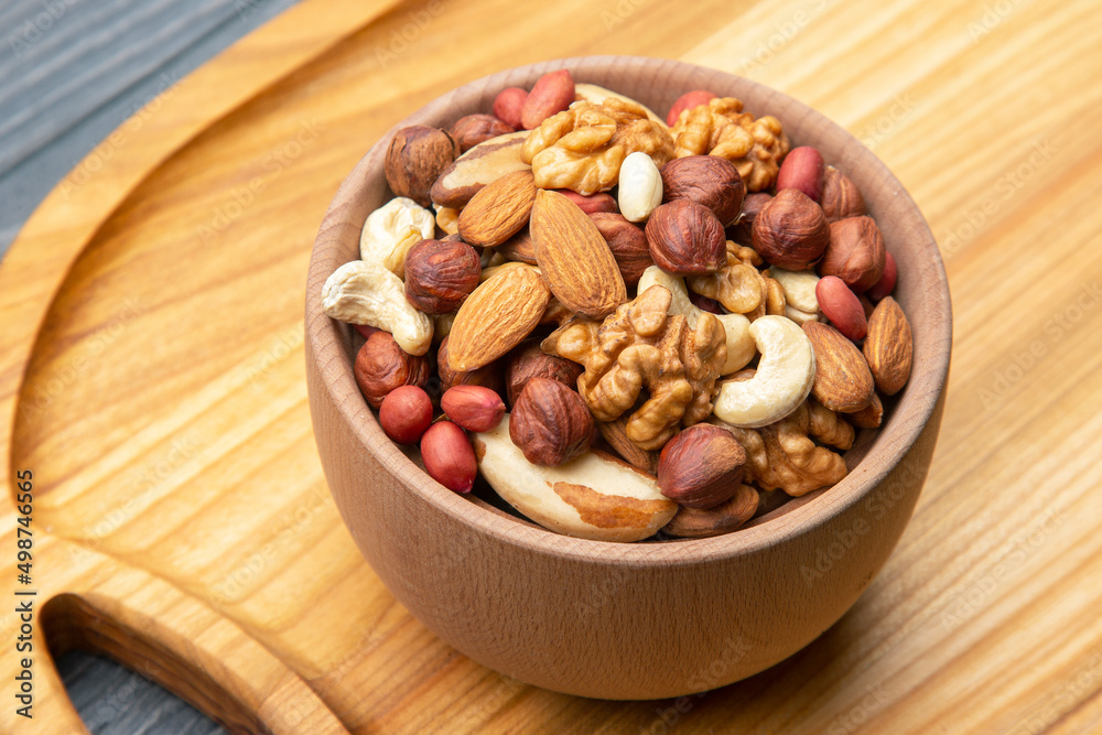 assorted nuts on a kitchen wooden board. vitamin vegetarian food assorted nuts on a kitchen wooden board. vitamin vegetarian food