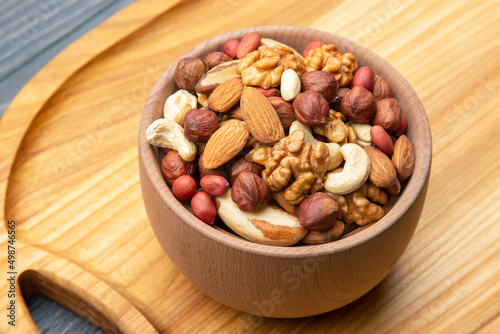 assorted nuts on a kitchen wooden board. vitamin vegetarian food