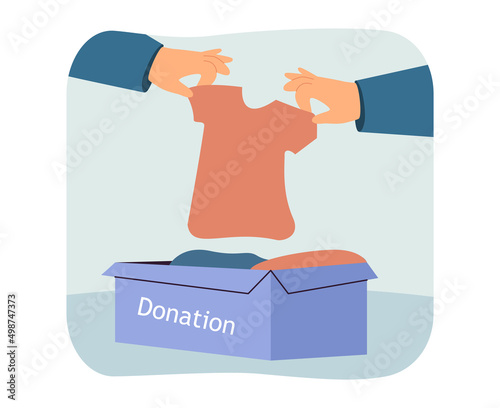 Hands taking T-shirt out of box with clothes. Volunteers giving clothes away to poor persons flat vector illustration. Charity, clothing donation concept for banner, website design or landing web page