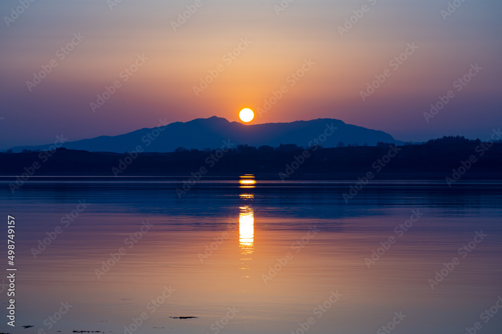 Sunset over mountains and sea in the west of Scotland Sunset over mountains and sea in the west of Scotland
