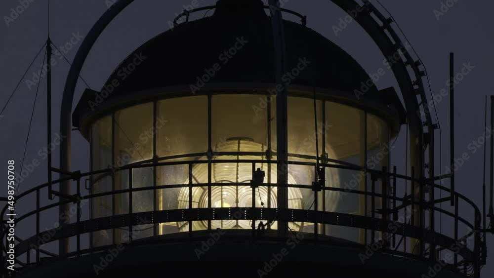 View Of Bevelled Fresnel Lens Spinning At Lighthouse In The Evening. Locked Off View Of Bevelled Fresnel Lens Spinning At Lighthouse In The Evening. Locked Off