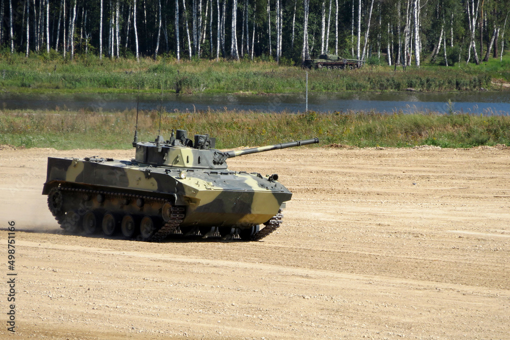 Russian tracked combat vehicle landing BMD-4M in battle on river bank on forest background Russian tracked combat vehicle landing BMD-4M in battle on river bank on forest background