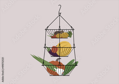 A layered hanging vase with fruits and vegetables, farmers market food