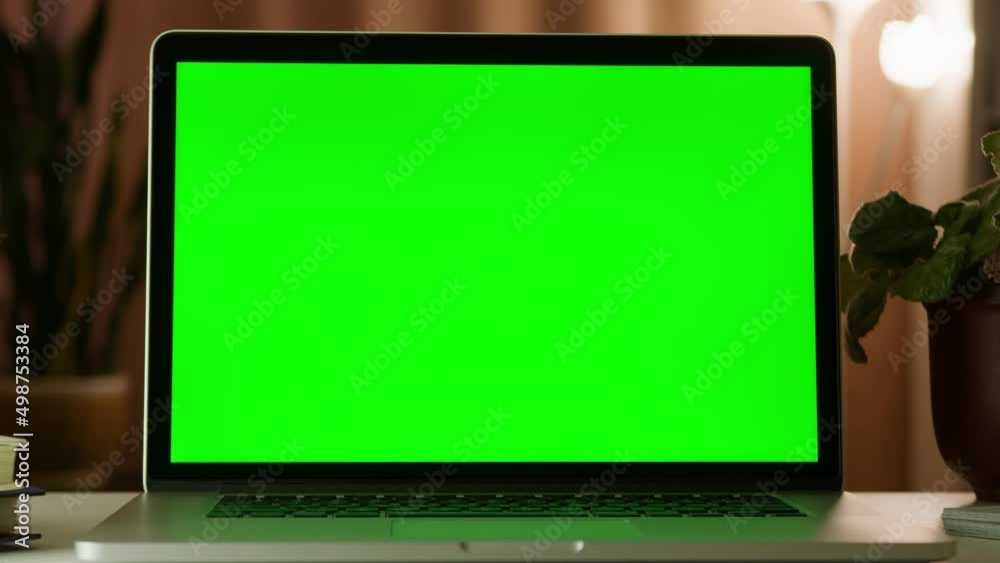 Modern laptop with blank green screen. Green screen freelance graphic designers laptop computer home work desk. Modern laptop with blank green screen. Green screen freelance graphic designers laptop computer home work desk.