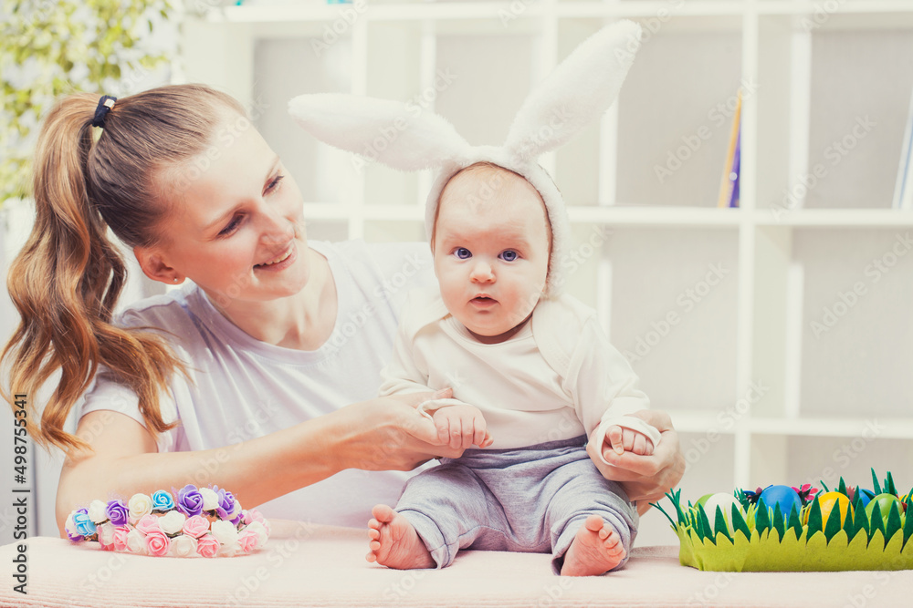 Happy Mother and baby with bunny ears playing Easter egg. Happy Mother and baby with bunny ears playing Easter egg.