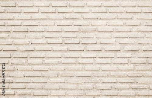 Cream and beige brick wall texture background. Brickwork and stonework flooring interior. 