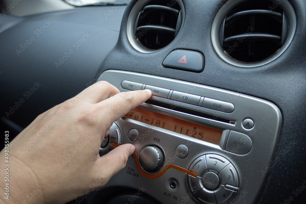 the finger press on the button at the control panel for play music in car