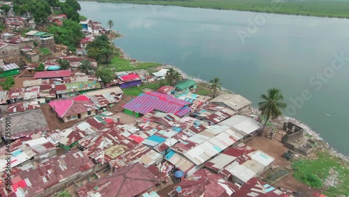 a poor slum area in Monrovia, Liberia with the Atlantic Coast of West Africa background photo