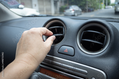 Driver hand tuning car air ventilation grille