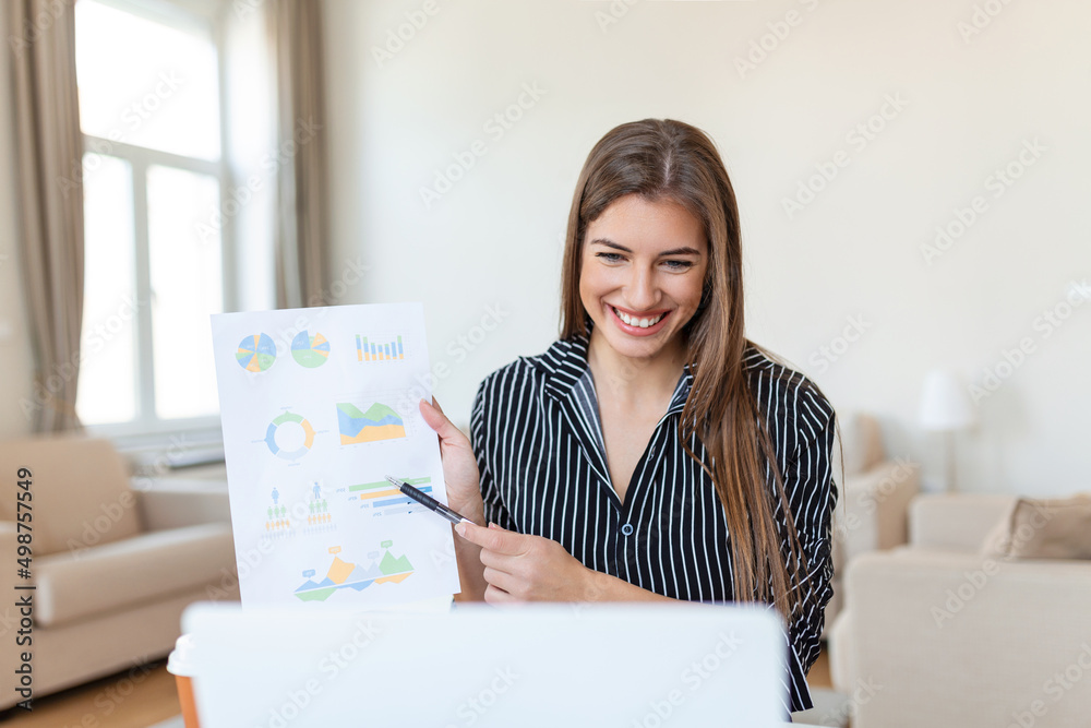 Focused business woman presenting charts and graphs on video call online. Young business woman having conference call with client on laptop. Young woman explaining how business work Focused business woman presenting charts and graphs on video call online. Young business woman having conference call with client on laptop. Young woman explaining how business work