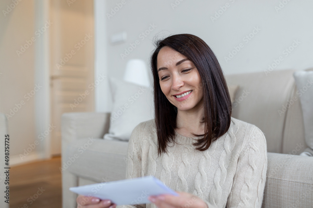 Cheerful Asian woman receiving invitation or good news about approved loan, mortgage, tax, insurance, getting notice about acceptance of statement Cheerful Asian woman receiving invitation or good news about approved loan, mortgage, tax, insurance, getting notice about acceptance of statement