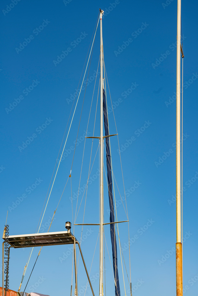 High masts sailing yacht against a blue sky. High masts sailing yacht against a blue sky.