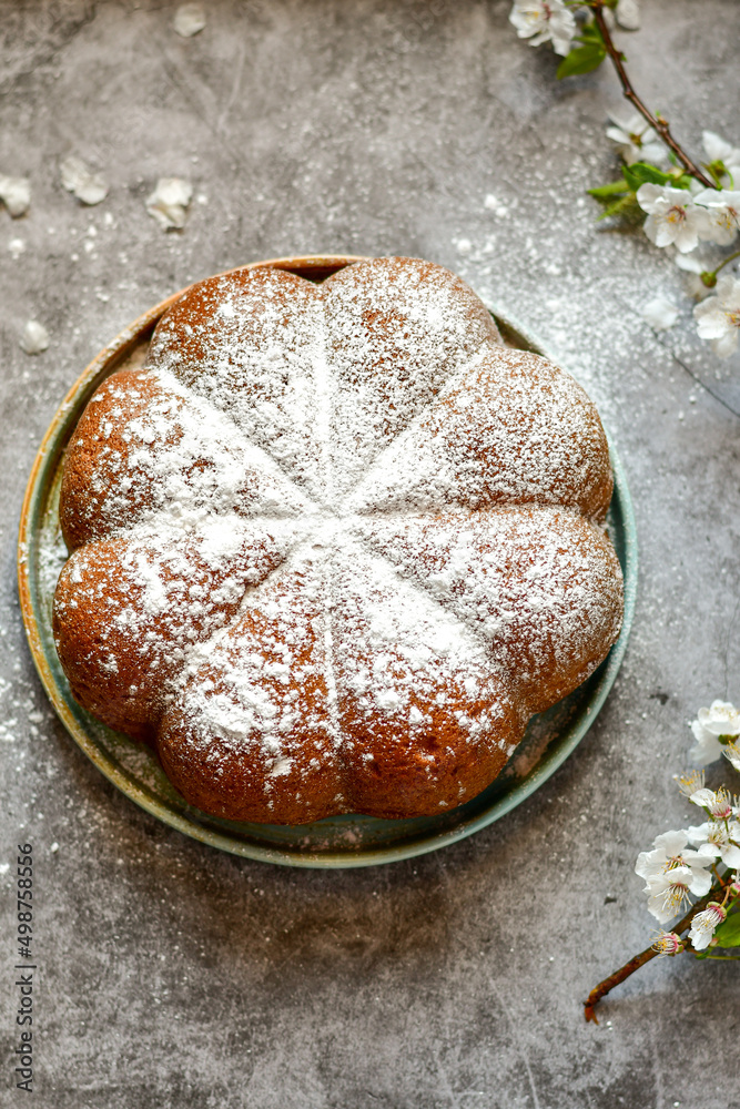 Homemade Italian style Easter bread cake, spring blossom and hand colored eggs. Homemade pastry. Easter holiday baking and decorarion Homemade Italian style Easter bread cake, spring blossom and hand colored eggs. Homemade pastry. Easter holiday baking and decorarion