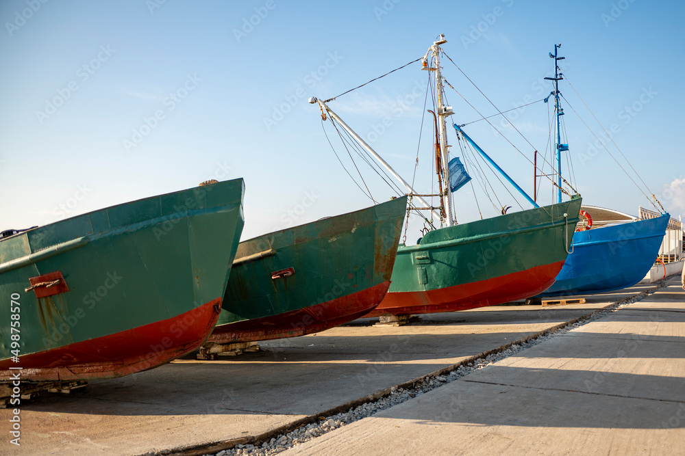 Fishing boats on the seashore. Boats against the blue sky.