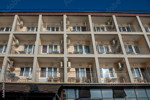 Facade of the hotel with summer balconies in the resort town.