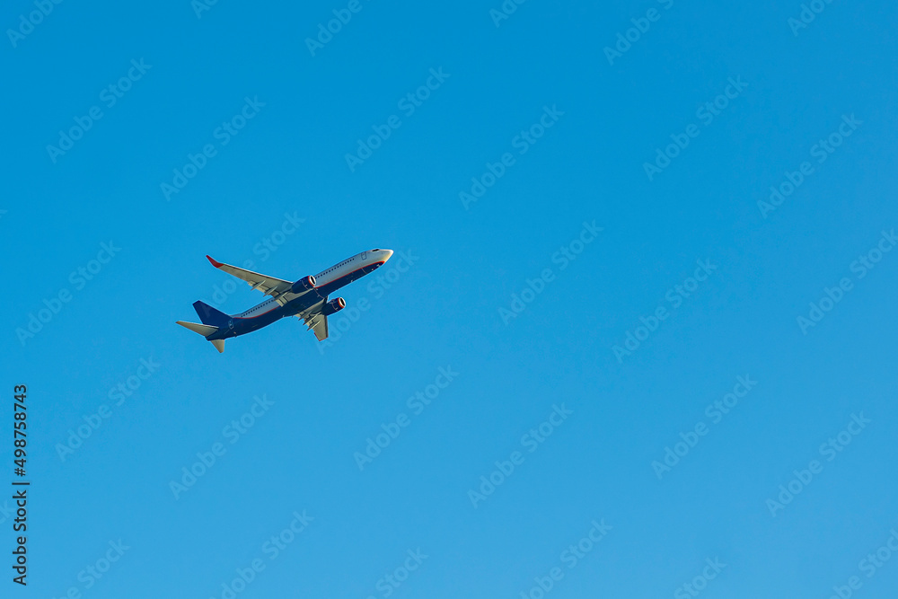 Blue passenger plane against the blue sky. Blue passenger plane against the blue sky.