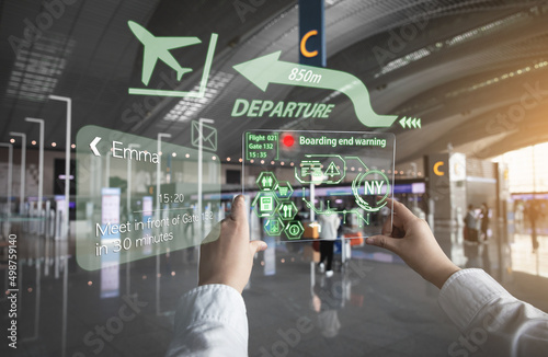 A woman receiving information using AR equipment at the airport (a hologram is displayed using a transparent acrylic plate) photo