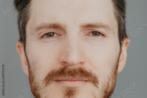 Close-up of the face of a handsome young man with brown eyes