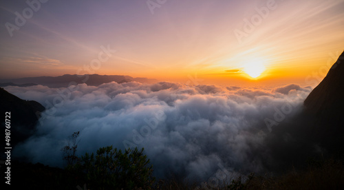 sunset over the mountains with awesome clouds, Creamy fog covered the mountain dramatic sunrise image taken from Munnar Kolukkumalai Kerala