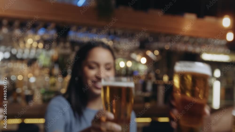 Multi-ethnic group of friends clink glasses at celebratory dinner at restaurant. Multi-ethnic group of friends clink glasses at celebratory dinner at restaurant.