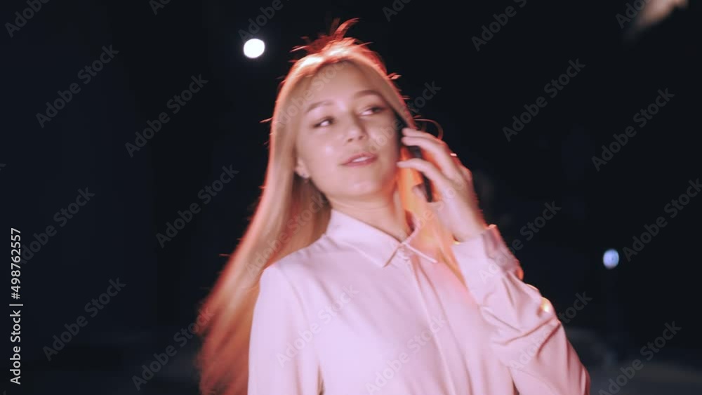 a beautiful girl talks on the phone and laughs. Beautiful lighting.Cute Sexy Blonde.Slow Motion a beautiful girl talks on the phone and laughs. Beautiful lighting.Cute Sexy Blonde.Slow Motion
