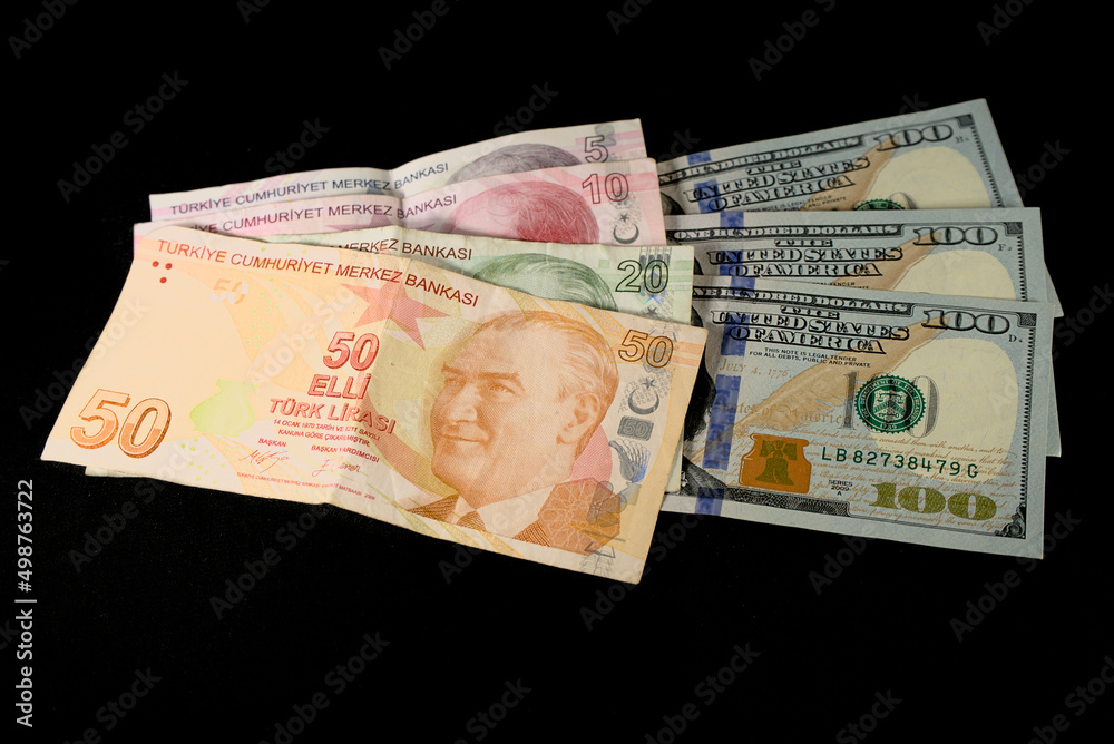 Turkish lira banknotes and American dollars on a black background Turkish lira banknotes and American dollars on a black background