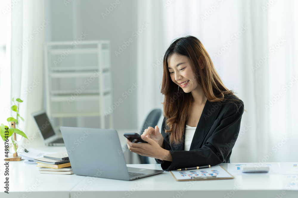 Asian businesswoman relax and enjoy chatting mobile phone at office. Asian businesswoman relax and enjoy chatting mobile phone at office.