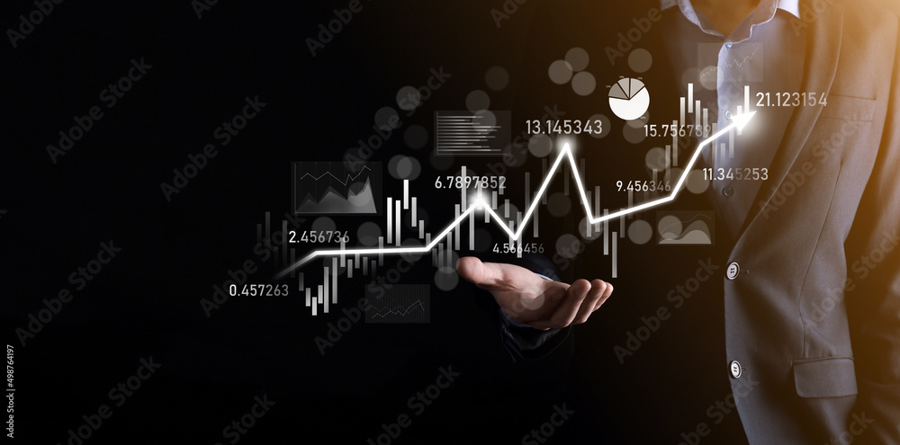 Fototapeta premium Businessman in hand hold banking business finance graph and invest in stock market investment point,economic growth and investor concept.analysis virtual stock market chart,analyze by use technology