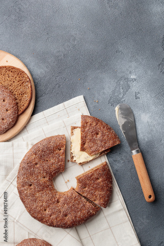 Reikäleipä - traditional finnish rye bread on a gray concrete background photo