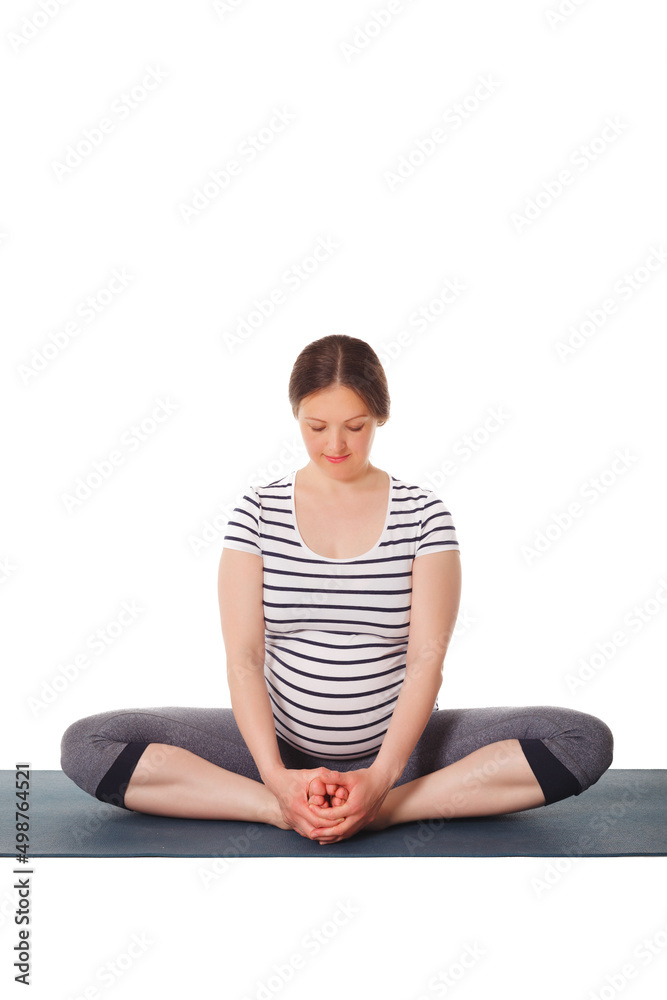 Pregnancy yoga exercise - pregnant woman doing asana Baddha Konasana Bound Angle Pose isolated on white background Pregnancy yoga exercise - pregnant woman doing asana Baddha Konasana Bound Angle Pose isolated on white background