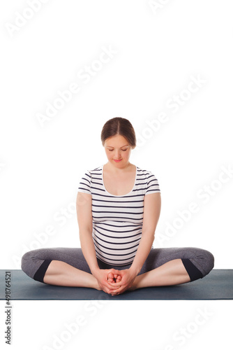Pregnancy yoga exercise - pregnant woman doing asana Baddha Konasana Bound Angle Pose isolated on white background