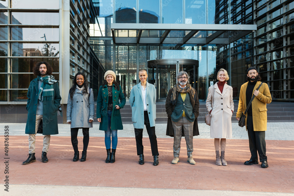 Fototapeta premium Diverse coworkers standing on street with glass walls
