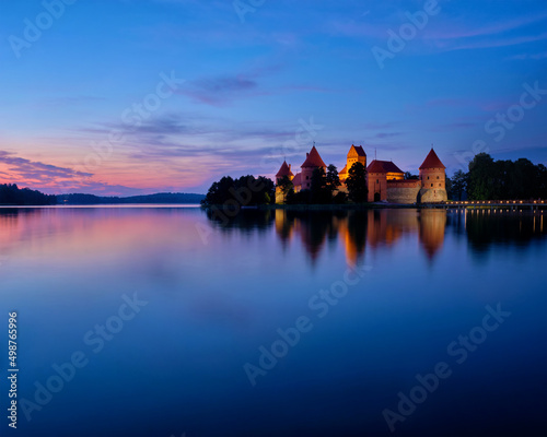 Evening view of Trakai Island Castle in lake Galve illuminated in the night, Lithuania