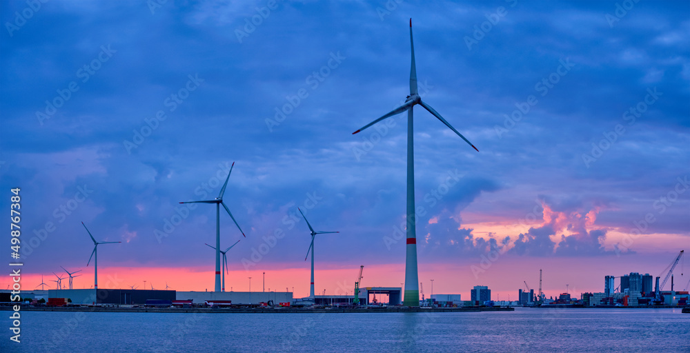 Panorama of wind turbines power electricity generators in Antwerp port in the evening. Antwerp, Belgium