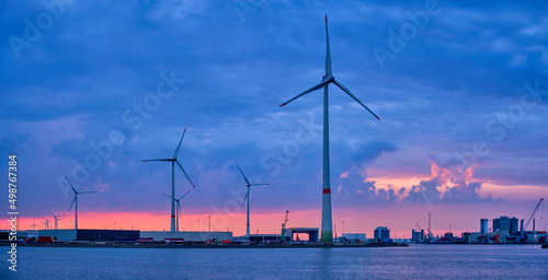 Panorama of wind turbines power electricity generators in Antwerp port in the evening. Antwerp, Belgium
