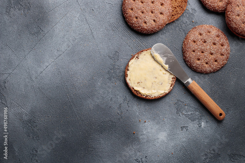 Ruisleipa - traditional Finnish rye bread with butter on a gray concrete photo