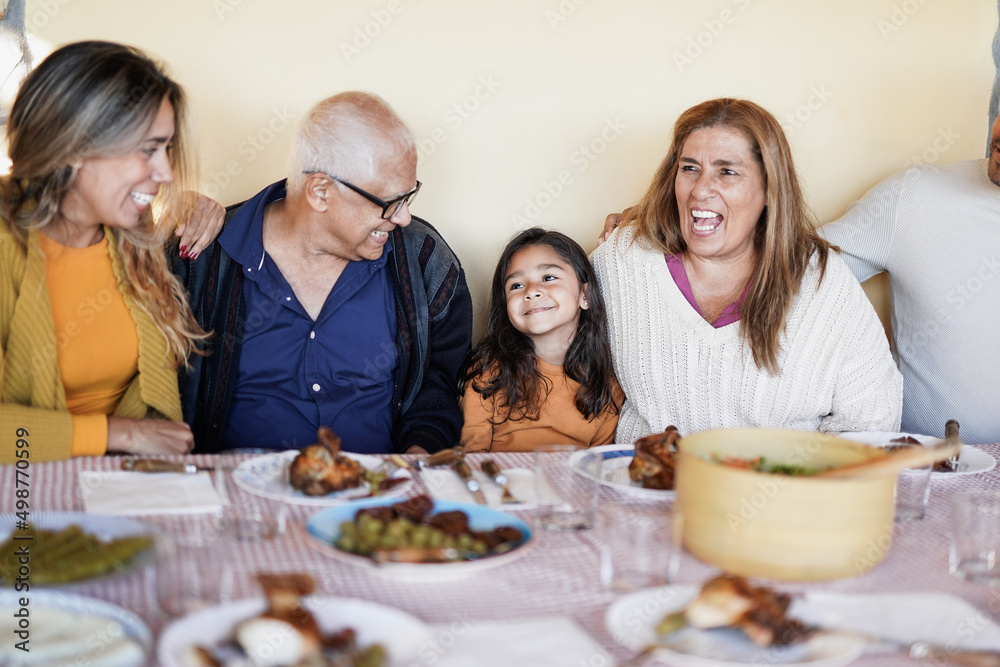 Happy latin family enjoy lunch together at patio