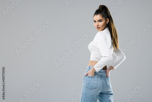 Rear view of woman in jeans isolated on white background